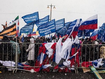 Митинг в честь 2-й годовщины аннексии, брошенные ушедшими флаги. Фото varlamov.ru/1620443.html